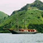 Angelica phinisi liveaboard under sail in Komodo National Park near Labuan Bajo