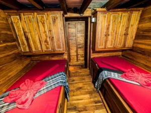 Twin cabin with wooden storage cupboards aboard Akomo Isseki