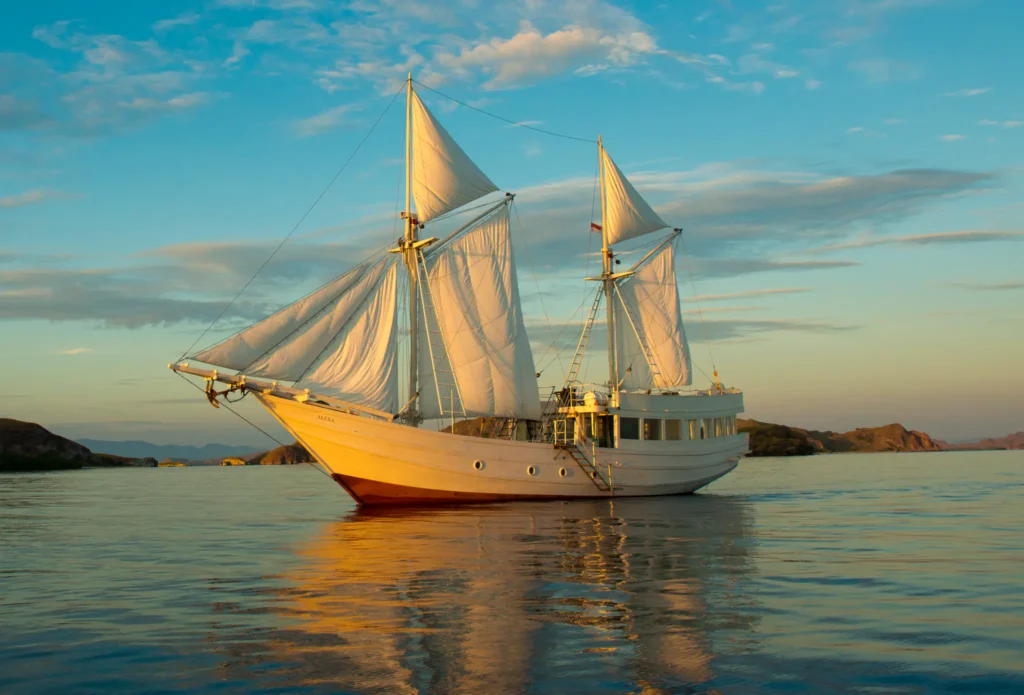 Alexa 31-metre phinisi sailing at sunset in Indonesia