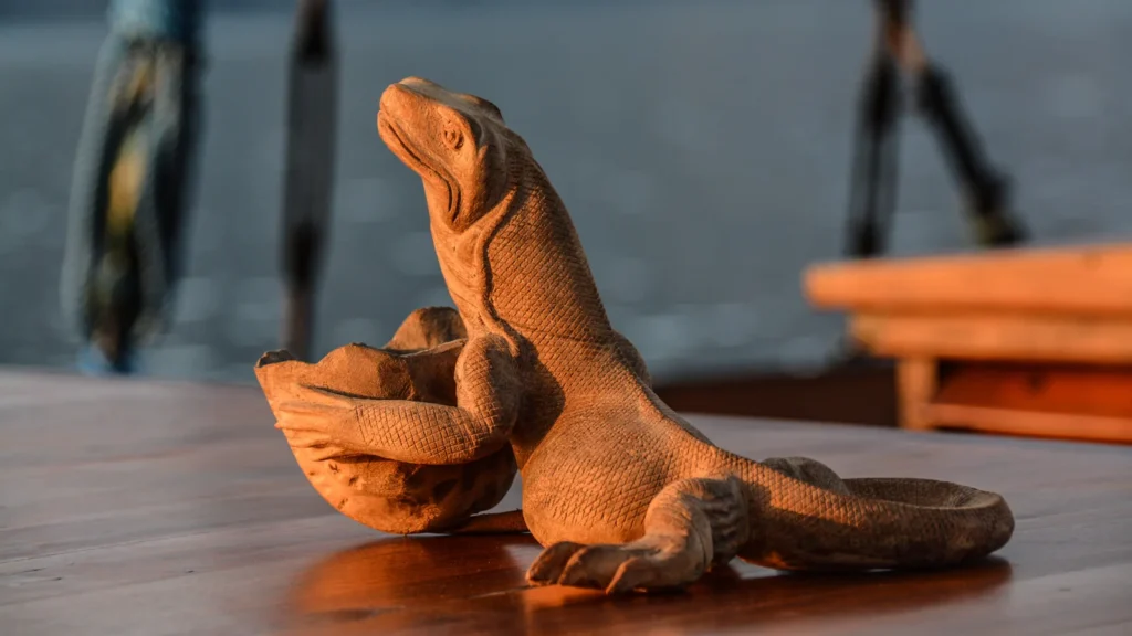 Wooden Komodo dragon carving on the deck of Ananda