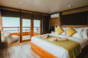 Double bed and private balcony in an Indo Master Superior Suite