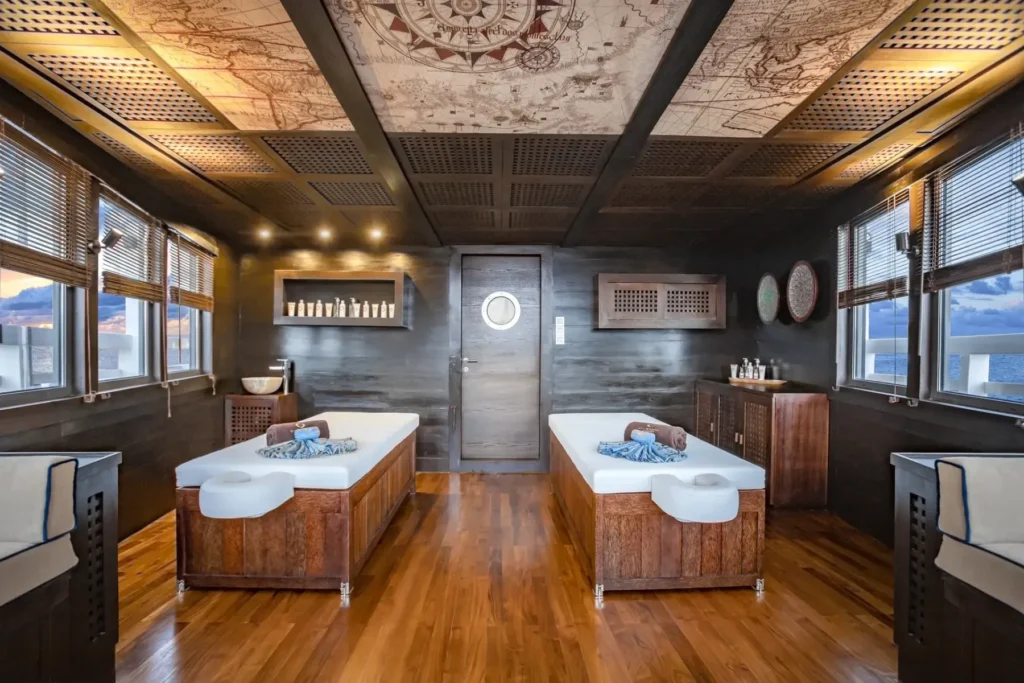 Onboard spa treatment room with twin massage beds aboard Scubaspa Zen
