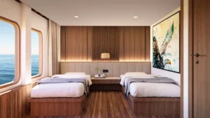 Elang Deluxe cabin on Sukha Sail 2 with twin beds and a sea-view window
