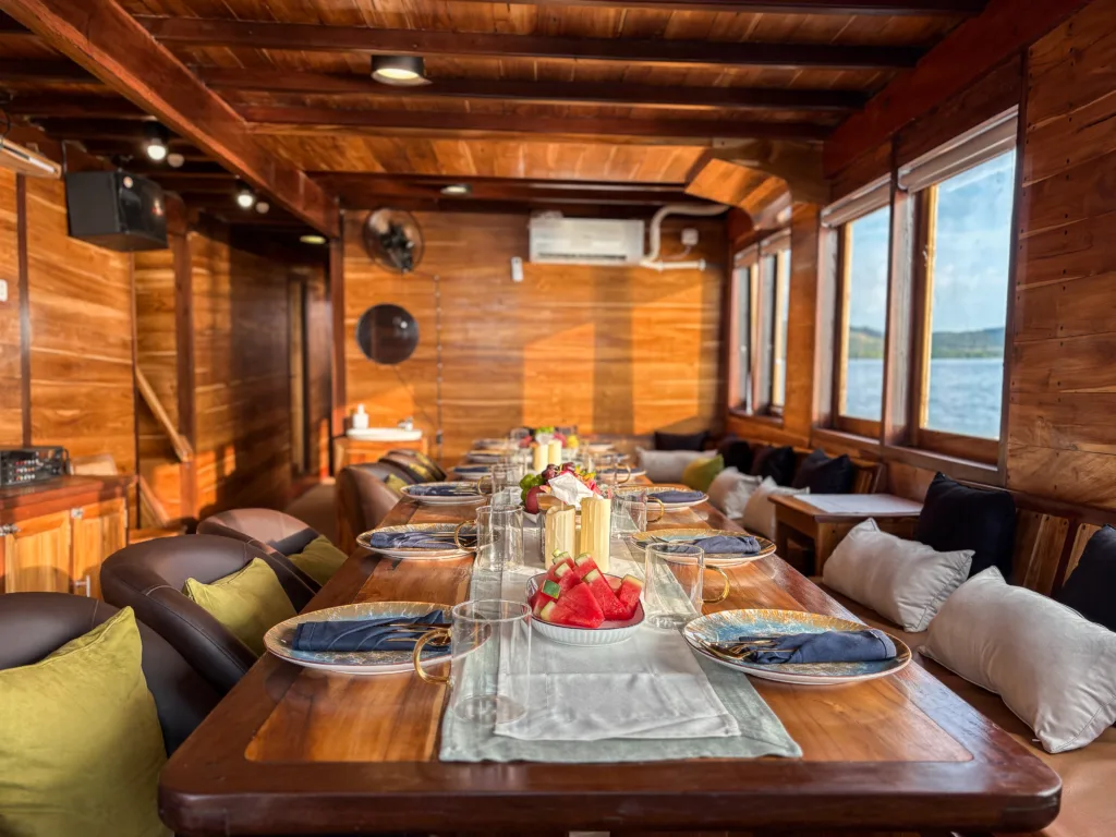 Indoor dining room with open kitchen aboard Sundari Voyages