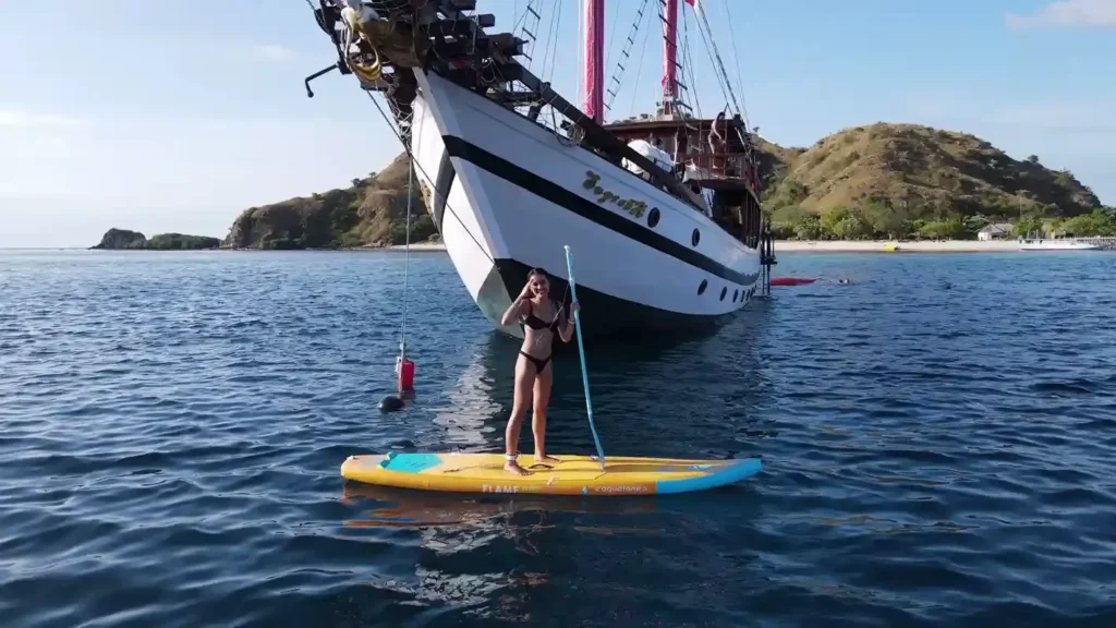 Guest paddleboarding during a Supraba liveaboard voyage