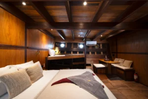 Ta’Talasa Bugis Cabin with king bed, seating and portholes