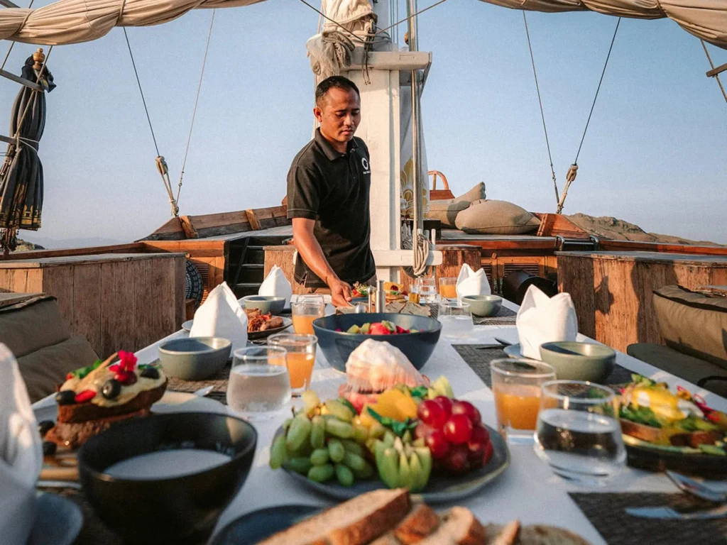 Alfresco dining table with ocean views aboard The Oracle yacht