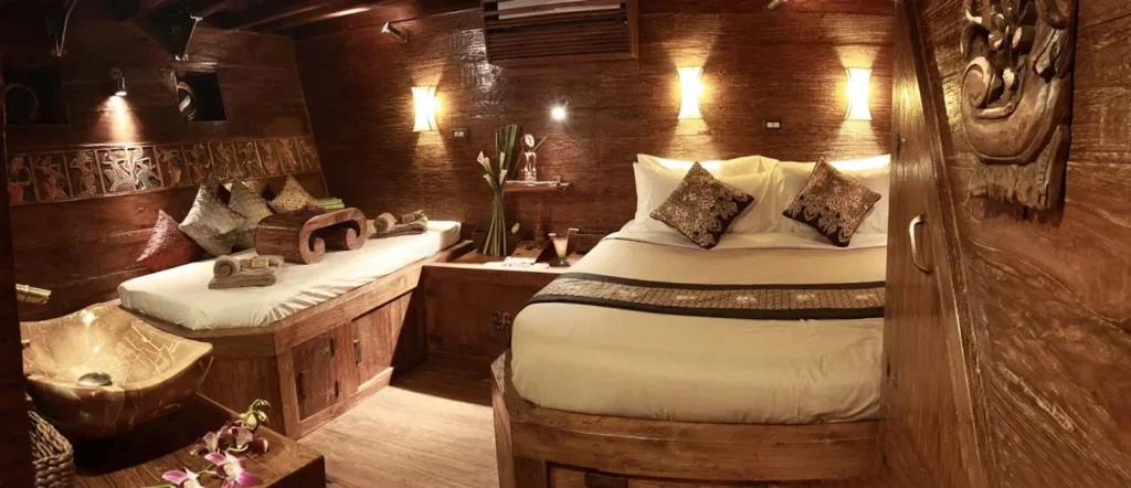 Lower-deck deluxe cabin with double bed and convertible sofa aboard Arenui