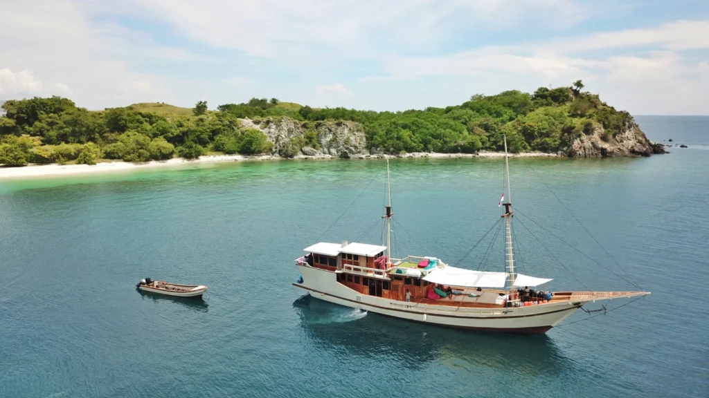 Aerial side view of Lalunia liveaboard near a Komodo island