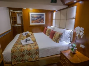 Deluxe cabin configured with a king bed aboard MV Mermaid I
