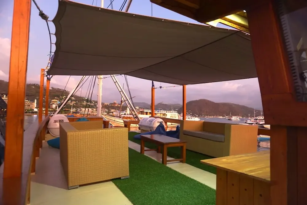 Shaded open-air sun deck lounge aboard MV NusaTara