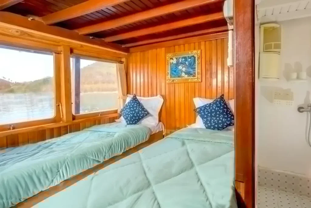 Upper-deck twin cabin with large windows aboard MV TemuKira