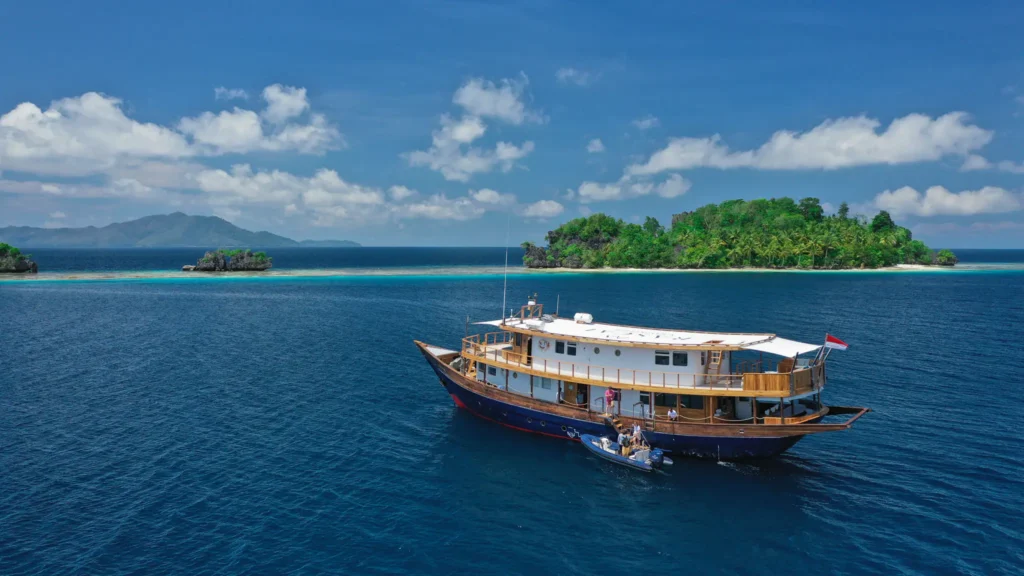 Rascal yacht cruising beside tropical islands in Indonesia