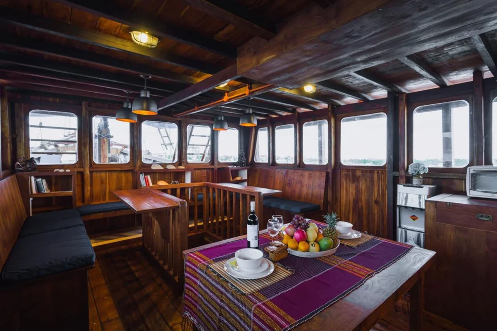 Wooden indoor lounge and dining space aboard Situju7
